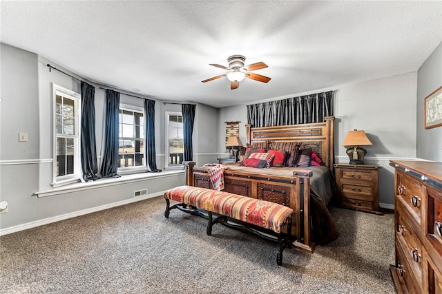 carpeted bedroom featuring a textured ceiling and ceiling fan