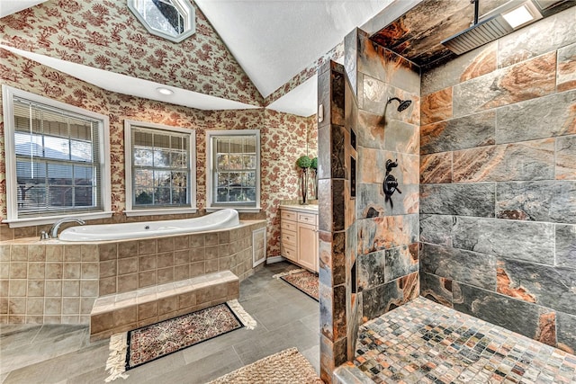 bathroom featuring tile patterned flooring, vanity, lofted ceiling, and independent shower and bath