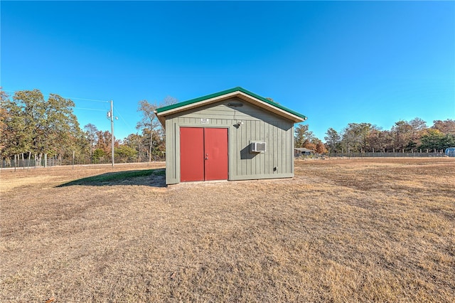 view of outbuilding with a wall unit AC