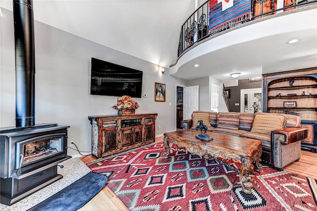 living room with a wood stove and wood-type flooring