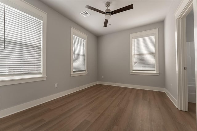 unfurnished room featuring dark hardwood / wood-style flooring and ceiling fan