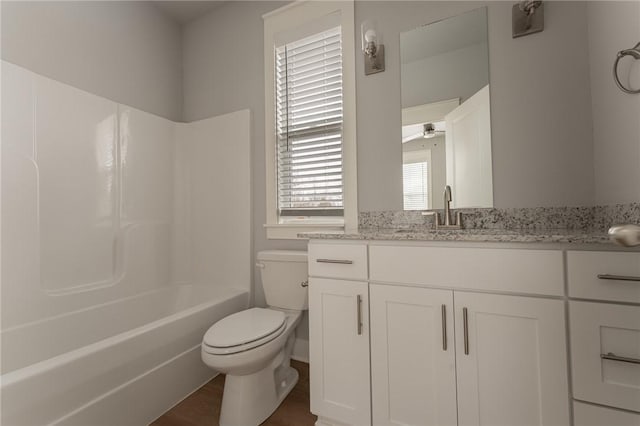 full bathroom with shower / bathing tub combination, vanity, toilet, and hardwood / wood-style floors