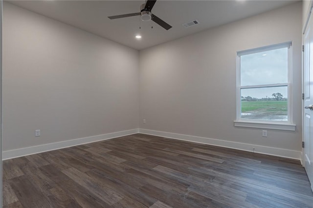 spare room with ceiling fan and dark hardwood / wood-style flooring