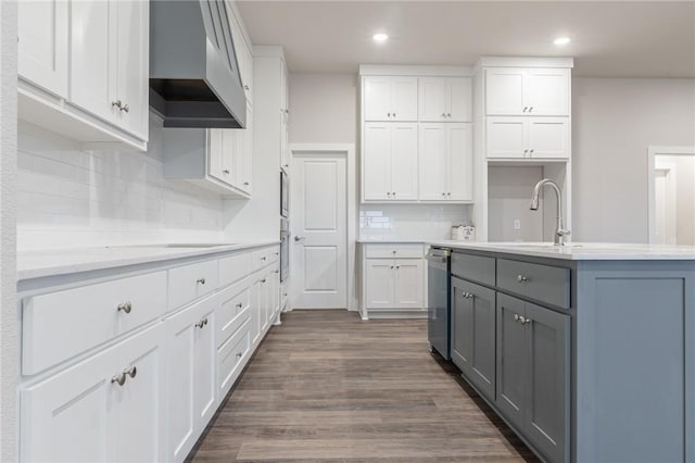 kitchen with white cabinets, sink, wall chimney exhaust hood, dark hardwood / wood-style floors, and gray cabinets