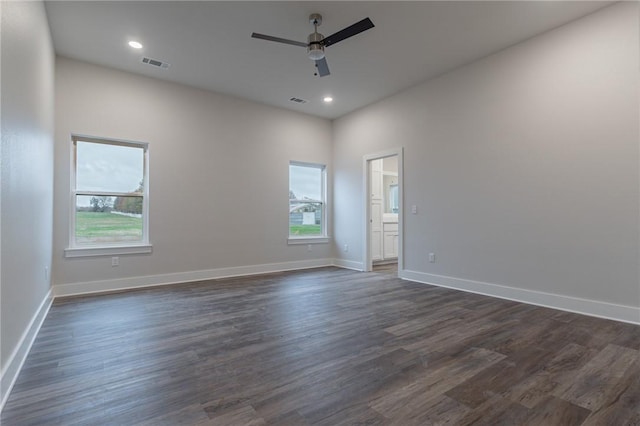 spare room with ceiling fan, dark hardwood / wood-style flooring, and a healthy amount of sunlight