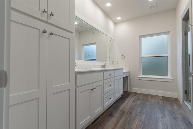 bathroom with vanity, wood-type flooring, and walk in shower