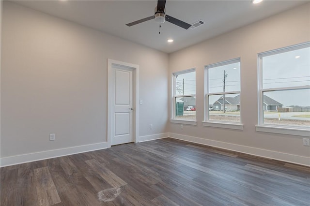 empty room featuring ceiling fan and dark hardwood / wood-style flooring