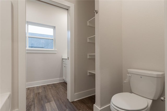 bathroom featuring toilet, vanity, and hardwood / wood-style flooring