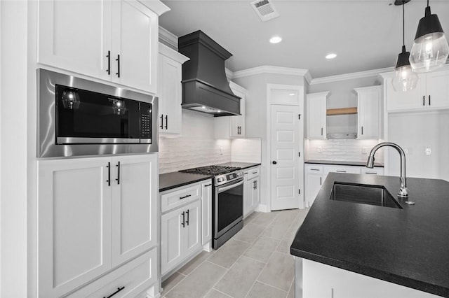 kitchen featuring white cabinets, stainless steel appliances, and sink