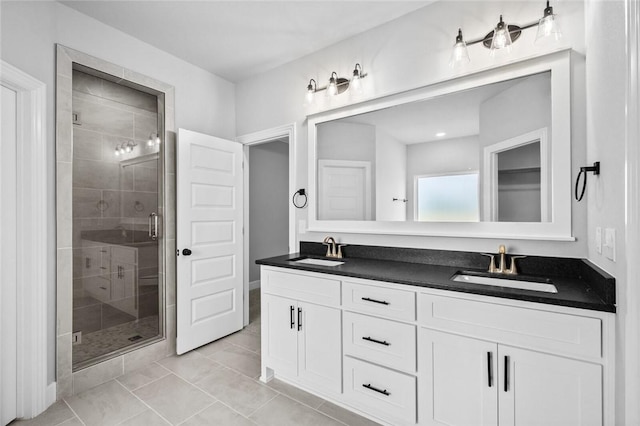 bathroom featuring tile patterned flooring, vanity, and an enclosed shower