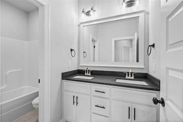 full bathroom featuring tile patterned flooring, vanity, toilet, and shower / washtub combination