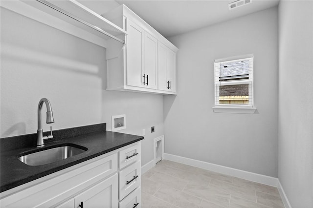 washroom with electric dryer hookup, cabinets, sink, washer hookup, and light tile patterned floors