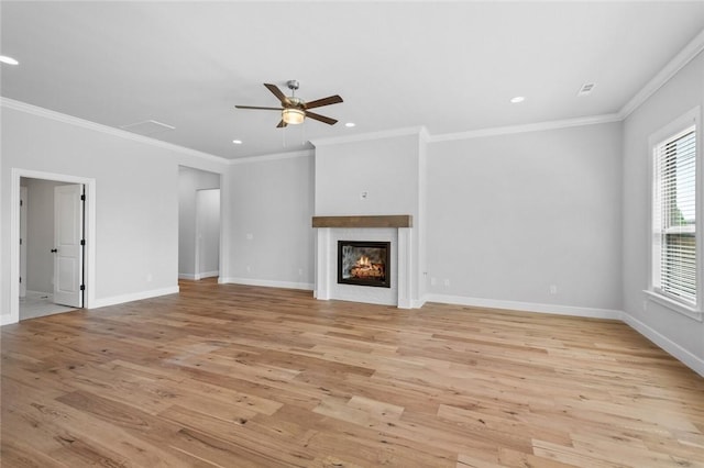 unfurnished living room featuring ceiling fan, ornamental molding, and light hardwood / wood-style flooring