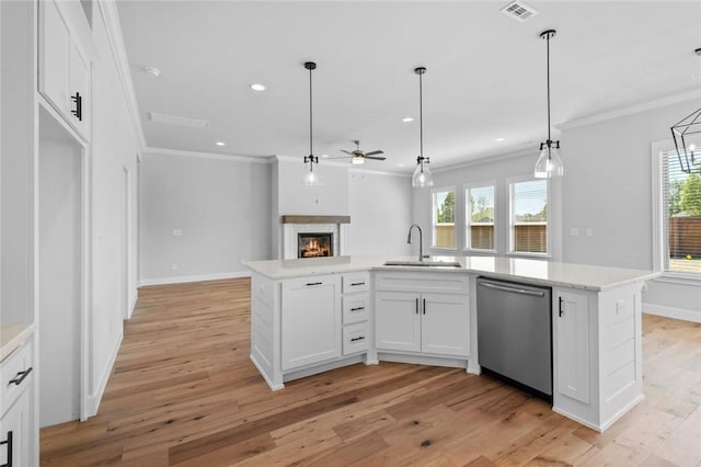 kitchen with a kitchen island with sink, dishwasher, white cabinets, and plenty of natural light