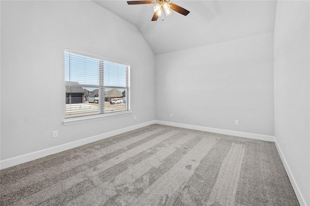 carpeted empty room with ceiling fan and vaulted ceiling