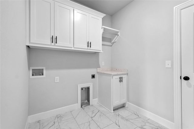 clothes washing area with electric dryer hookup, hookup for a washing machine, and cabinets