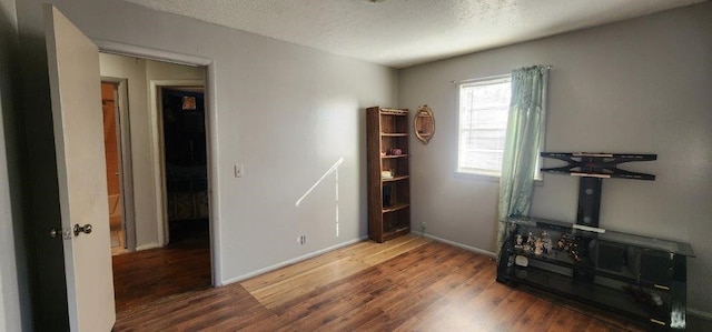 miscellaneous room featuring hardwood / wood-style floors and a textured ceiling