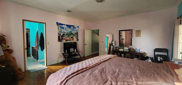 bedroom featuring crown molding and wood-type flooring