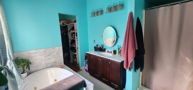 bathroom featuring vanity and a washtub