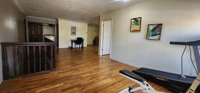 workout room with crown molding and dark hardwood / wood-style flooring