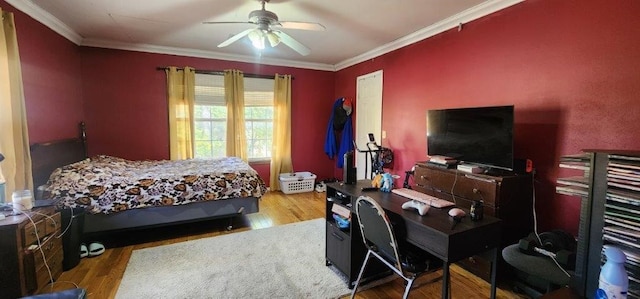 bedroom featuring hardwood / wood-style flooring, ornamental molding, and ceiling fan