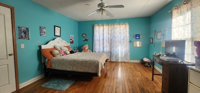 bedroom with ceiling fan and wood-type flooring