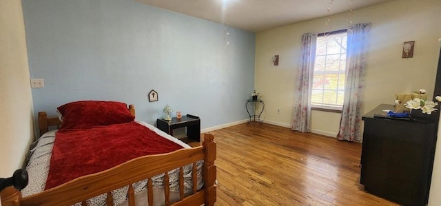 bedroom with hardwood / wood-style floors