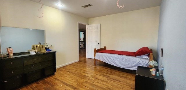 bedroom with hardwood / wood-style floors