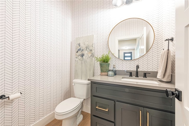 bathroom featuring hardwood / wood-style flooring, vanity, toilet, and tile walls