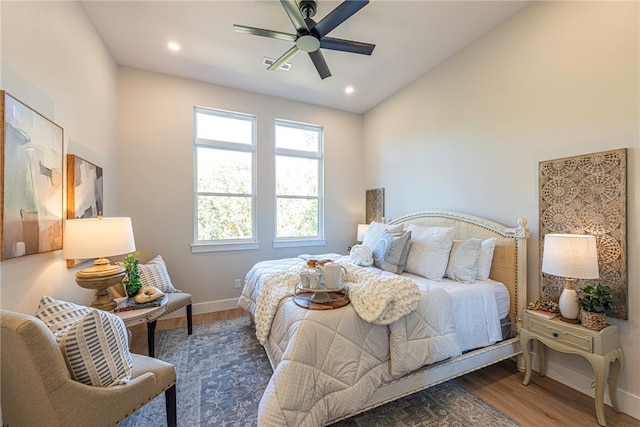 bedroom with dark wood-type flooring, ceiling fan, and lofted ceiling