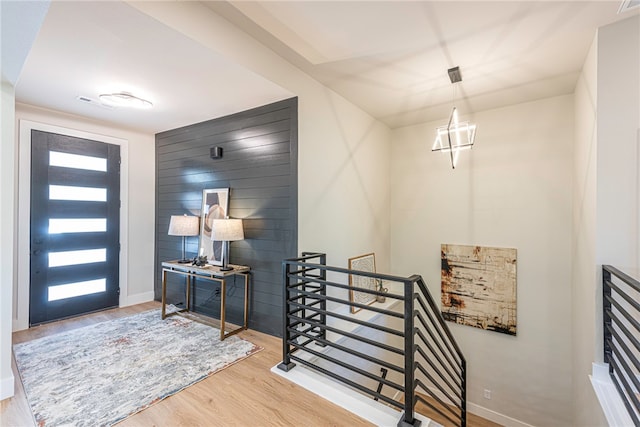 entrance foyer with an inviting chandelier and hardwood / wood-style floors