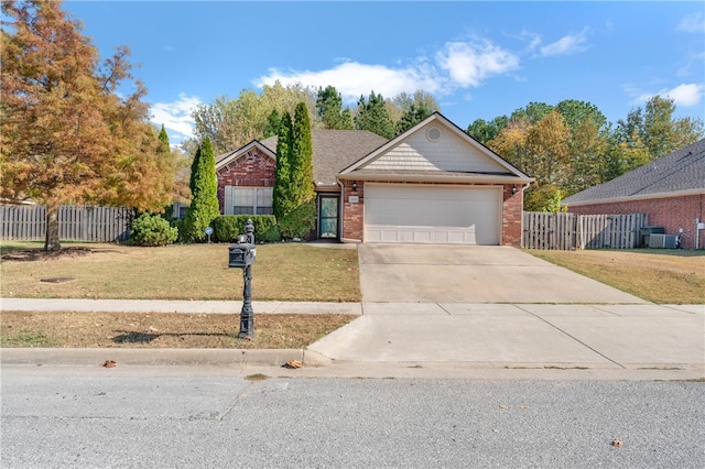 single story home with cooling unit, a front yard, and a garage