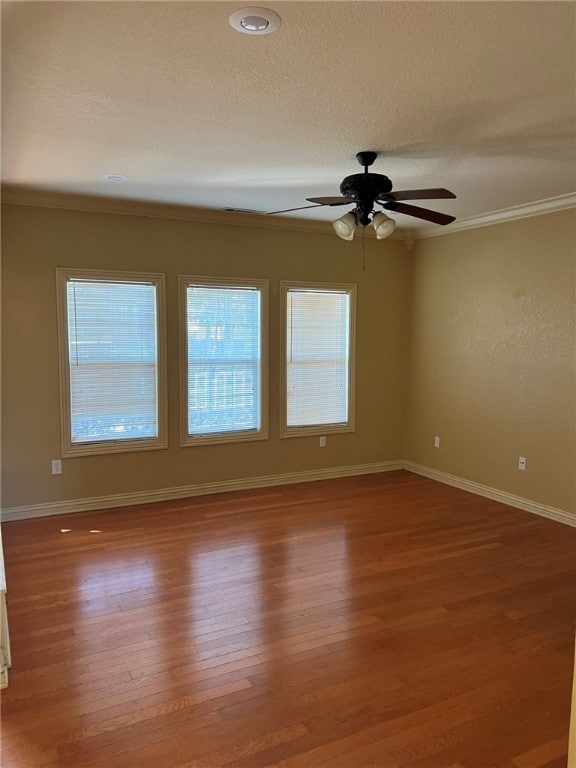 spare room with crown molding, a textured ceiling, wood-type flooring, and ceiling fan