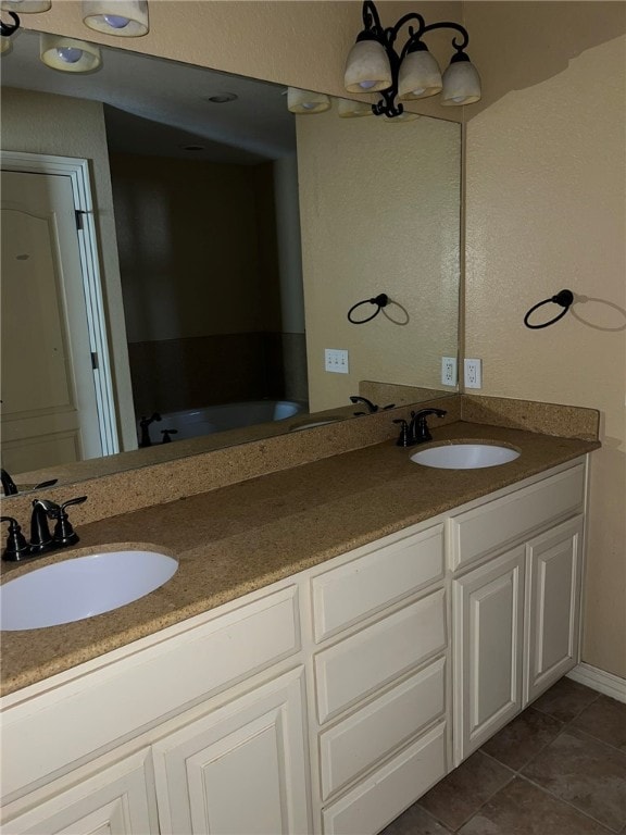 bathroom featuring vanity, an inviting chandelier, and tile patterned flooring