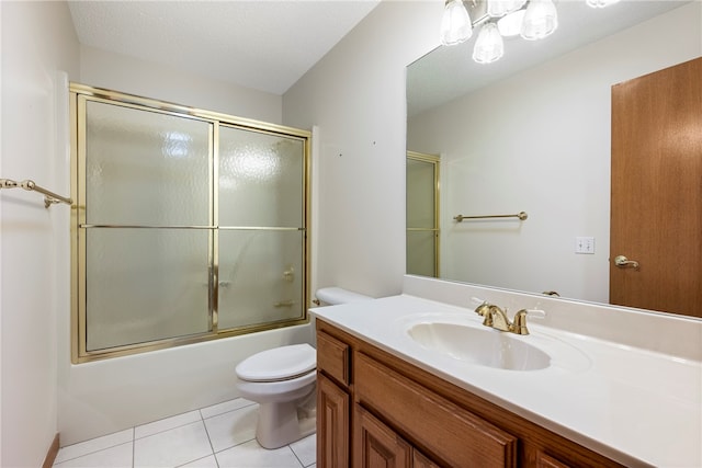 full bathroom with tile patterned floors, vanity, a textured ceiling, shower / bath combination with glass door, and toilet