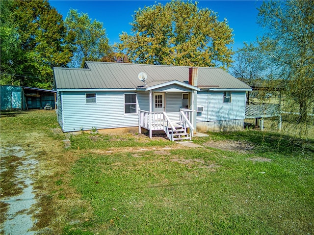 back of house with a lawn