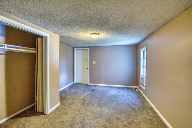 unfurnished bedroom with a textured ceiling, carpet floors, and a closet