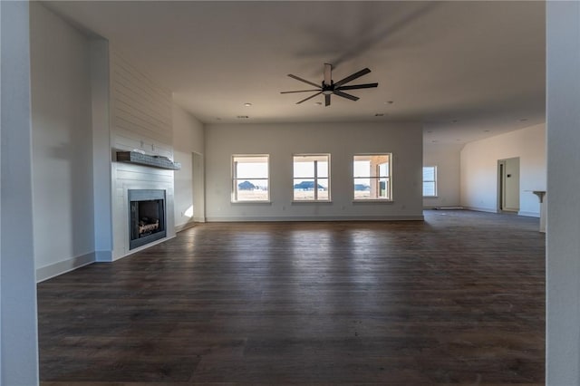 unfurnished living room featuring ceiling fan and dark hardwood / wood-style floors