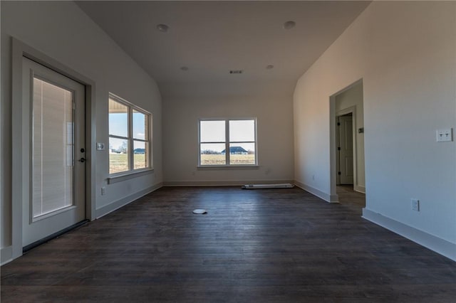 unfurnished room with dark hardwood / wood-style flooring and vaulted ceiling