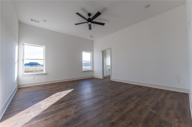 spare room featuring ceiling fan and dark wood-type flooring