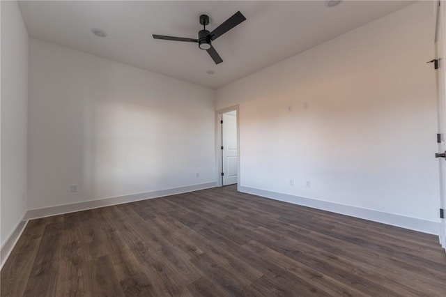 spare room featuring ceiling fan and dark wood-type flooring