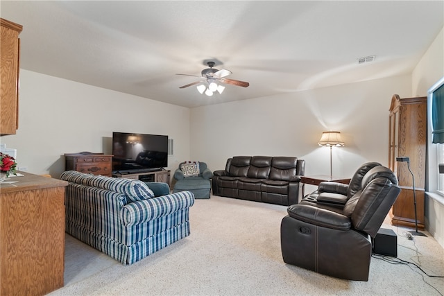 carpeted living room with ceiling fan