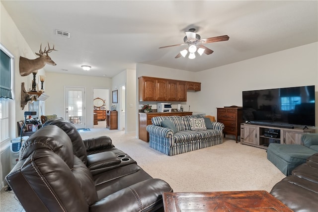 living room featuring ceiling fan and light carpet