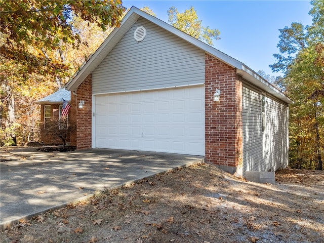 view of side of property with a garage and an outdoor structure