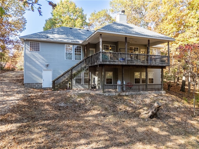 back of house with a wooden deck and ceiling fan