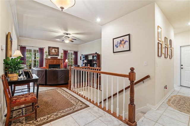 interior space with ceiling fan and ornamental molding