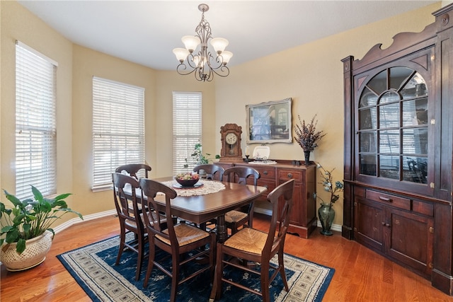 dining area featuring an inviting chandelier and light wood-type flooring