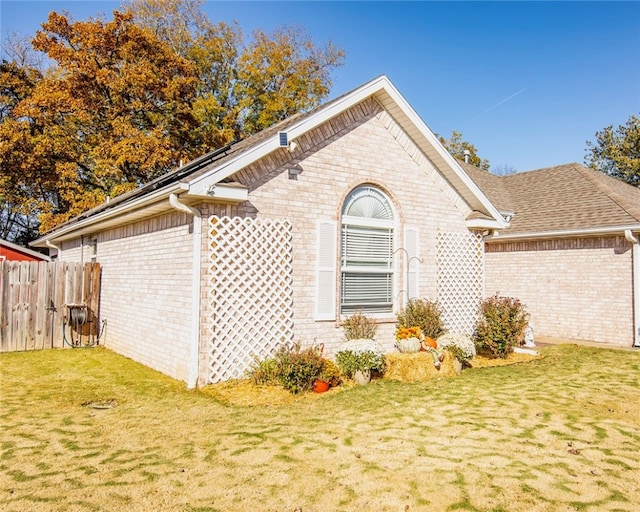 view of side of property with a lawn