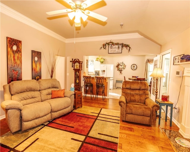 living room featuring ceiling fan, crown molding, vaulted ceiling, and light hardwood / wood-style flooring