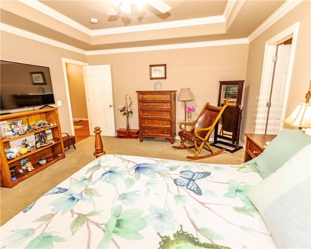 bedroom with light carpet, crown molding, a tray ceiling, and ceiling fan